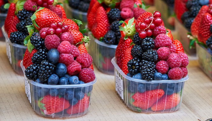 This image shows boxes of mixed berries. — Unsplash